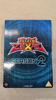 Front cover of the Yu-Gi-Oh! Zexal Season 2 DVD box set showing the title and design.