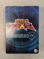 Front cover of the Yu-Gi-Oh! ZEXAL Season 3 DVD boxset featuring logo and design elements.