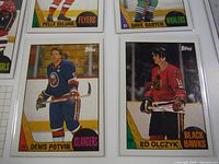 Close-up photo showing detailed front view of two hockey cards featuring Denis Potvin (Islanders) and Ed Olczyk (Blackhawks) from the 1987 Topps set.