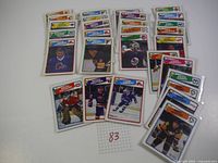 Overview photo showing 29 hockey cards laid out, grouped by player and arranged in rows