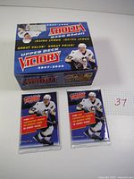 Original display box for 2007-08 Upper Deck Victory hockey card packs with two sealed packs in front