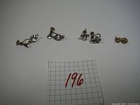 Three pairs of vintage clip-on earrings with rhinestone embellishments, displayed with a numbering card.