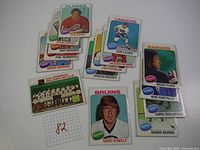 Lot of 15 1975 Topps hockey cards featuring several NHL players and one team card.
