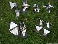 Top view showing all five sets of casters with various wheel sizes from 2-4 inches, black wheels and metal mounting plates on grass surface.