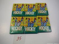 Six unopened packs of 1990-91 O-Pee-Chee hockey cards laid out on a flat surface.