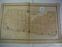 Full open spread of detailed map showing Durham County townships with orange borders, water bodies, rail lines, and township names.