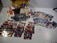 Overview of the full card collection showing various hockey cards spread and stack boxes containing more cards.