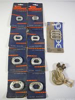 Eight zinc-plated chain connecting links from Big Orange brand, in original packaging, arranged on table.