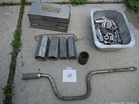 Photo showing all items laid out: 3/8" speed handle, four large extra sockets, a large single socket, tray with assorted old sockets, three-level handmade stainless steel box.