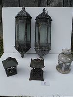 All four garden lanterns displayed against white backdrop outdoors, showing size and design.