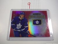 Front view of the 2020 Upper Deck Ilya Mikheyev hockey card with red reflective finish, player image, and jersey patch.