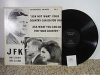 Front of vinyl record cover with photos of John F. Kennedy and quote