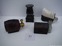 Photo showing all four Western-themed miniatures including pot-bellied stove, log cabin, covered wagon, and barrel with spigot.