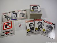 Stack of FBI's Most Wanted trading cards from 1993 along with firearm and Coalition to Stop Gun Violence cards displayed
