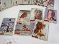 Photo showing multiple vintage collectible cards from 1981 'Here's BO' series laid out and fanned out. Cards include images of a female model in beach, jungle, and portrait settings.