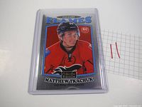 Front side of Matthew Tkachuk OPC Platinum Silver Rookie Card in clear protective case showing player portrait with Calgary Flames uniform.