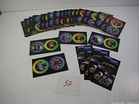 27 Star Trek collectible cards arranged spread out, showing various characters and scenes from the series with colorful circular borders.