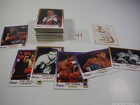 Full lot photo showing a stack of 100 Kaya boxing cards laid out around an ID card with number 47, alongside several loose cards depicting boxers in various poses and action shots.