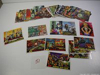 Complete overlapping layout of 57 vintage Mars Attacks trading cards on white background with handwritten number 57 on a grid paper.