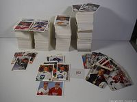Large stacks of Upper Deck hockey cards arranged on a flat surface, with several cards spread in front showing player images and logos.