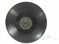 Full view of the black 78 RPM record showing the grooves and the obstruction free surface.