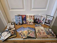 Full view of assorted DVDs including TV series sets and music DVDs, arranged for viewing.