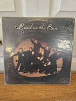 Front cover of the vinyl LP album showing band members and title "Band on the Run" by Paul McCartney and Wings with price marking.