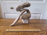 Full side view of the "Freedom Flight" sculpture showing overall shape, size reference with 12-inch ruler.