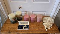 Top view of all items including candles, wall sconce, and pen set arranged on table.