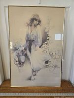 Full view of the framed Sara Moon print showing the woman standing barefoot in a flowing dress and signature of the artist on the lower right.