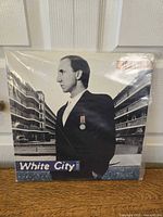 Front cover of 'White City: A Novel' vinyl album by Pete Townshend showing the man in profile with apartment buildings background.