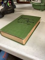 Side angle view of the 1914 Tarzan of the Apes book showing green cloth cover and thickness