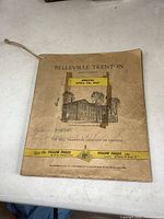 Front cover of 1957 Belleville-Trenton phone book showing an illustration of a building, text indicating effective date April 7th, 1957 and Bell Telephone Company of Canada branding.