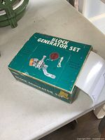 Original box front and top of the 12 volt bicycle block generator set showing images and branding