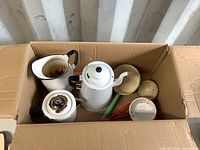 Box of assorted vintage enamel ware items including kettles, pitcher, small pots, and ladle with visible wear and chips.