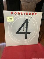 Front cover of Foreigner 4 album showing large number 4 and Foreigner logo