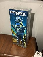 Sealed Robby the Robot box from Forbidden Planet with artwork showing the full front of the box, clear plastic wrapping intact.