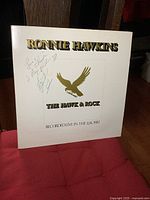 Full front cover of the vinyl album showing title, eagle graphic, and autograph signatures.