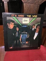 Front cover of the "It's Hard" album by The Who showing the band members and the album title.