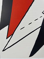 Close-up of red, white and black shapes showing print color and paper texture