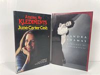 Photo of two books side by side: "Among My Klediments" by June Carter Cash and "Sandra Shamas: Autobiology of a Performances"