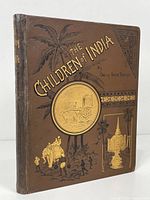 Front cover of 'The Children of India' book showing brown hardback with detailed gold and black embossed illustrations and title.