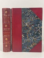 Front cover and spine of one volume showing red half leather binding and marbled board with gilt decorations on spine