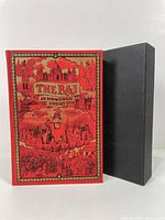 Front cover of The Raj hardcover book and black slipcase showing intricate historical illustrations in red, gold and black.