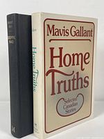 Both signed hardcover books upright and side-by-side, showing front cover of Mavis Gallant's "Home Truths" and spine of Ronald Atkin's "Dieppe 1942".