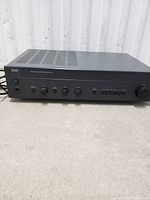 Front view of NAD 314 amplifier showing power button, knobs and controls