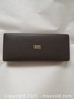 Brown leather-like rectangular pen case with gold Cross logo on top