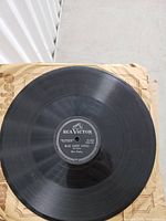 Photo of first 78 RPM record with RCA Victor label, titled Blue Suede Shoes by Elvis Presley. Shows record surface condition.
