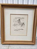 Black and white lithograph in giltwood frame showing a seated figure with text 'L’Hareng Saur' at the top.
