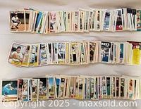 Three rows of loose baseball cards laid out, showing various card backs and fronts in fair to good condition from late 70s to 90s era.